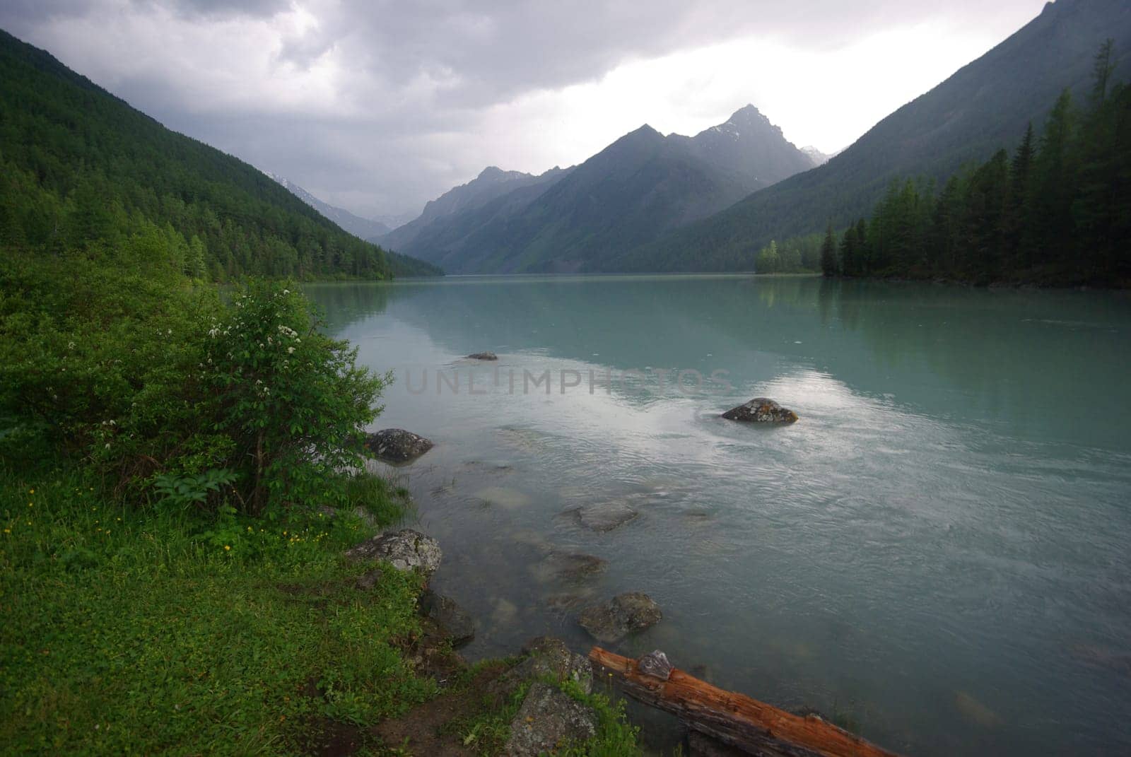Beautiful mountain landscape near the lake. Mountain Lake. Kind of mountainous terrain and the water in the valley.