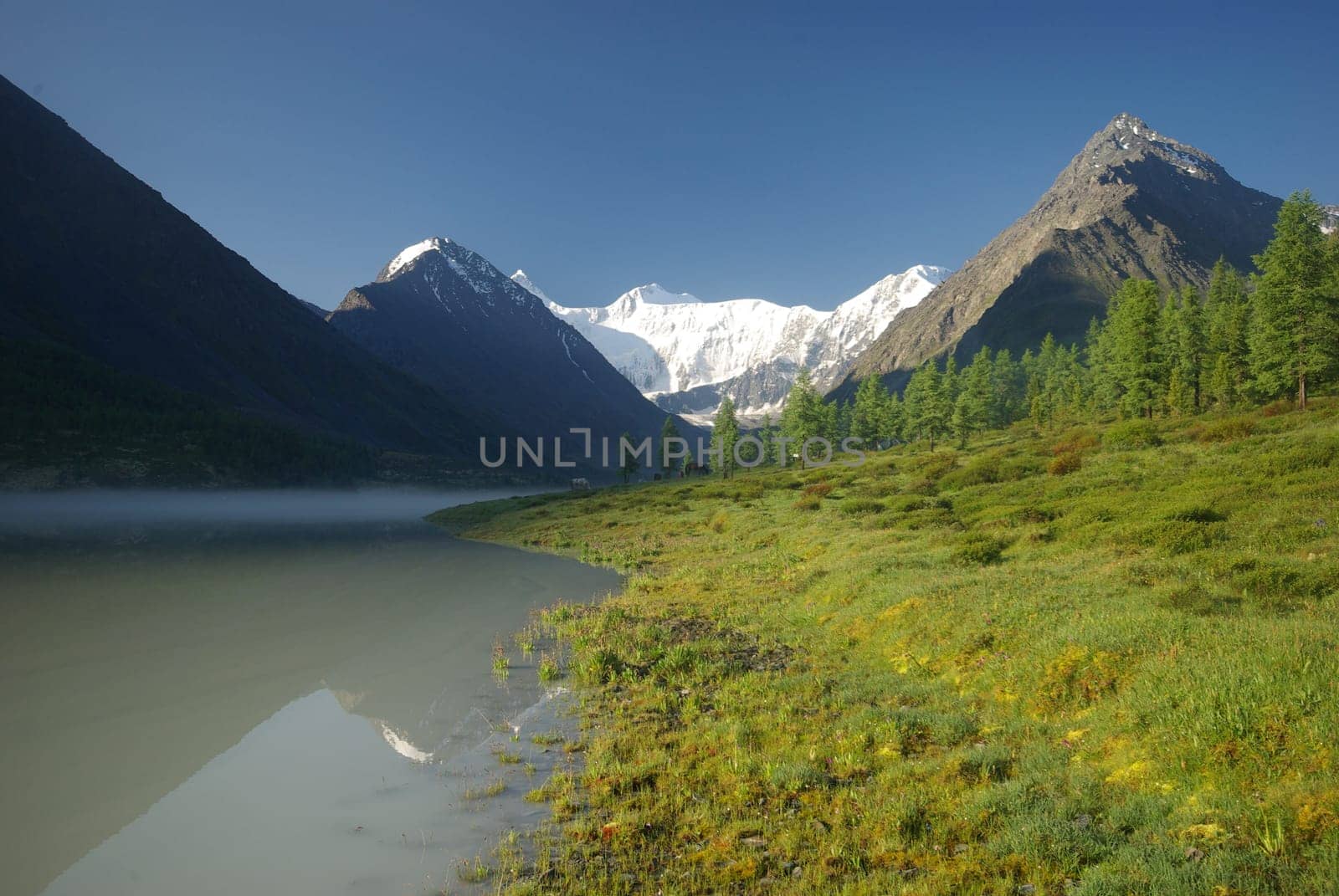 Beautiful mountain landscape near the lake. Mountain Lake. Kind of mountainous terrain and the water in the valley.