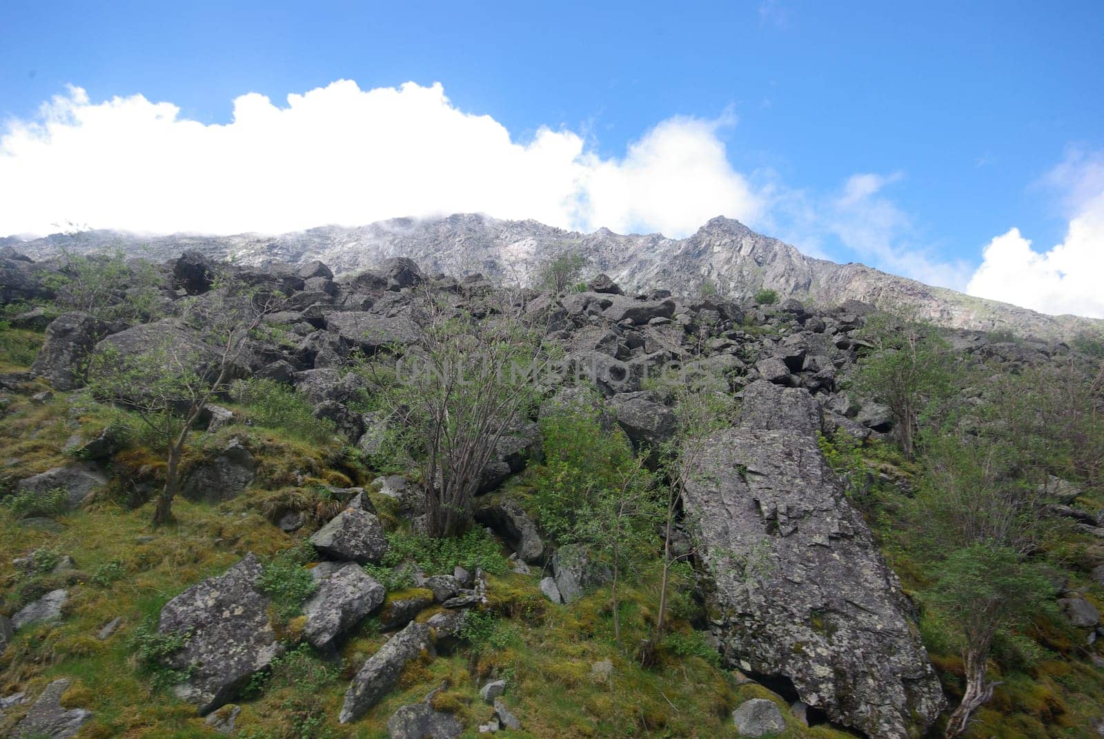 Mountain landscape. Highlands, the mountain peaks, gorges and valleys. The stones on the slopes.