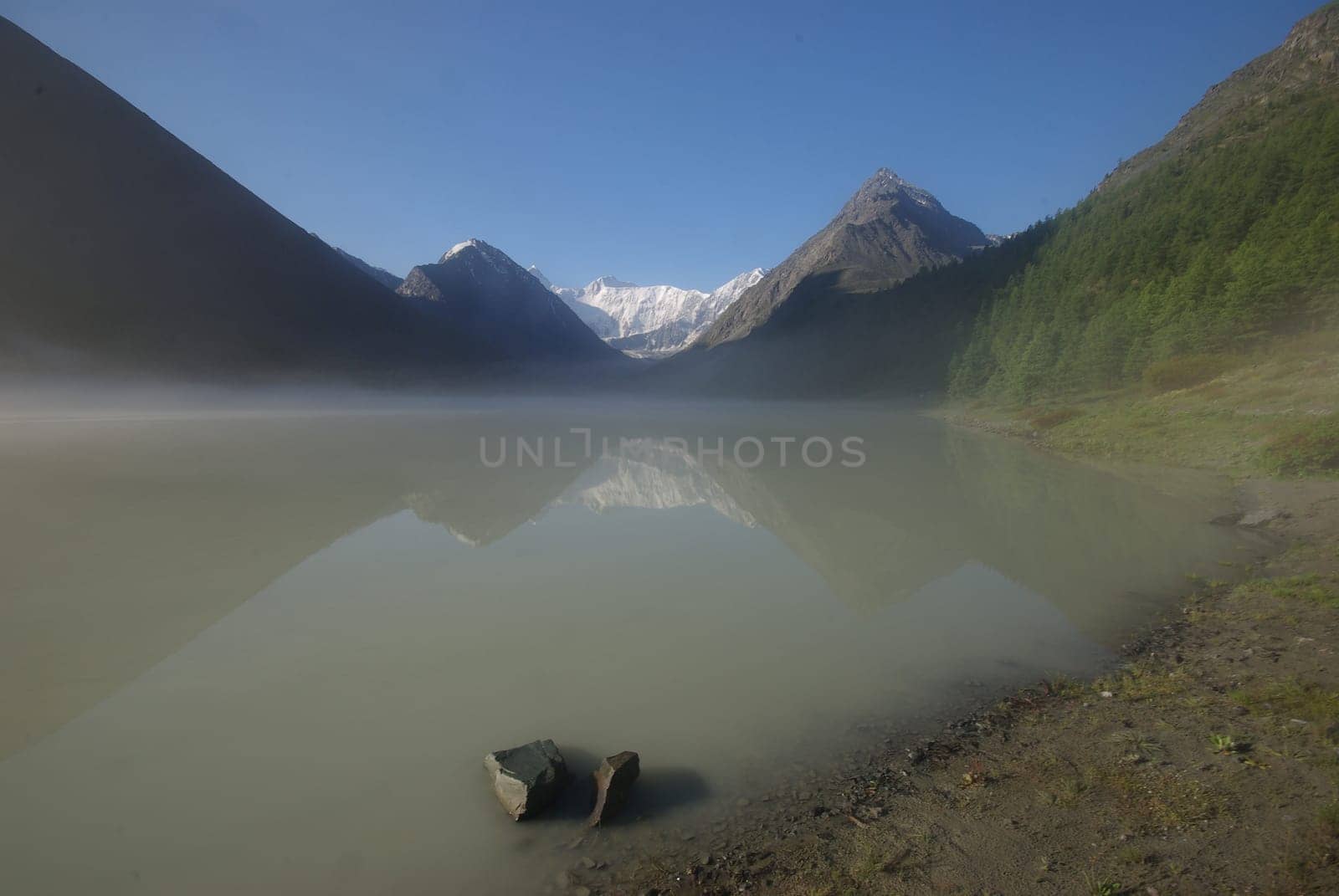 Beautiful mountain landscape near the lake. Mountain Lake. Kind of mountainous terrain and the water in the valley.
