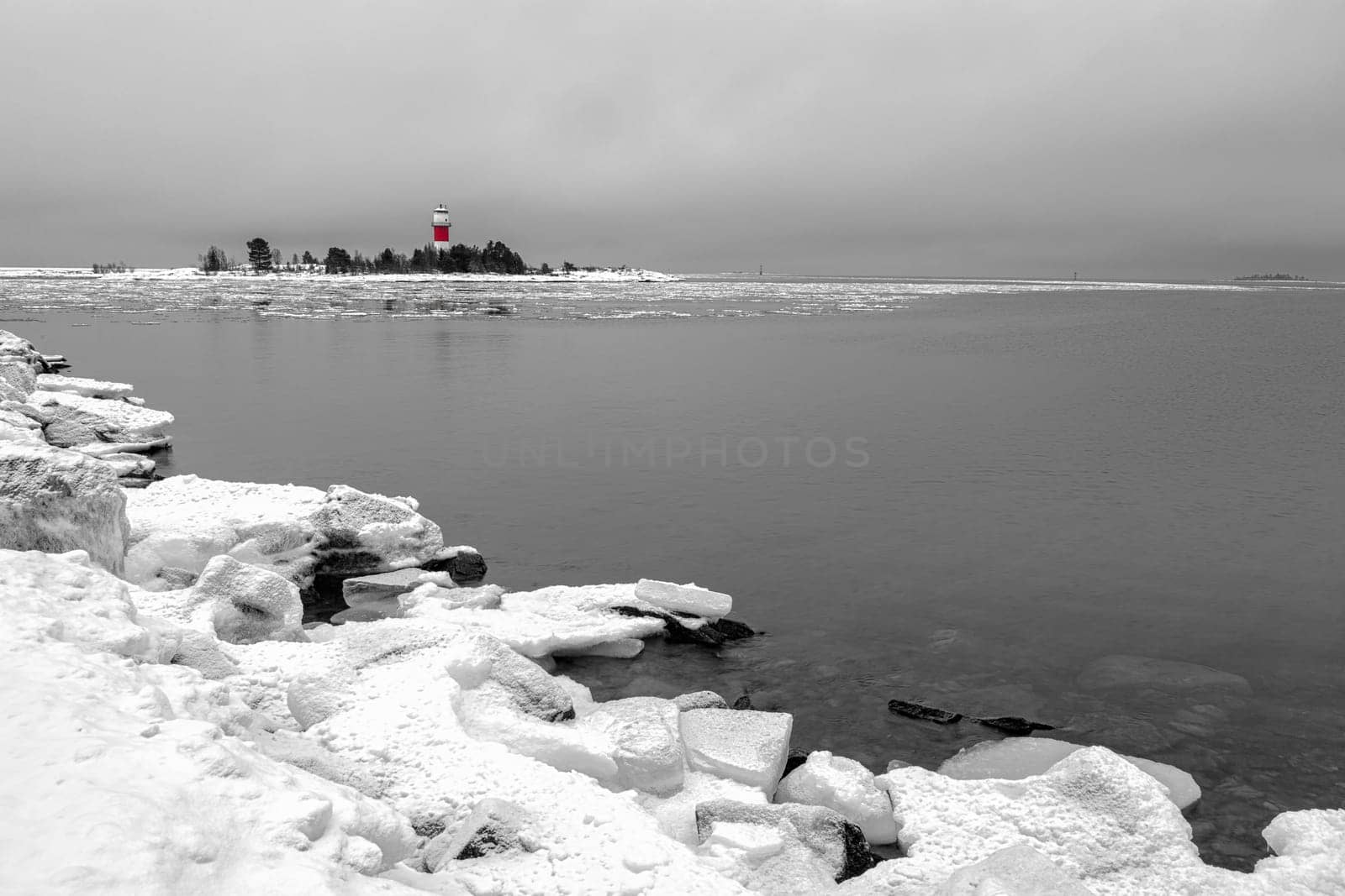 Light House with Icy Ocean and a cloudy sky.