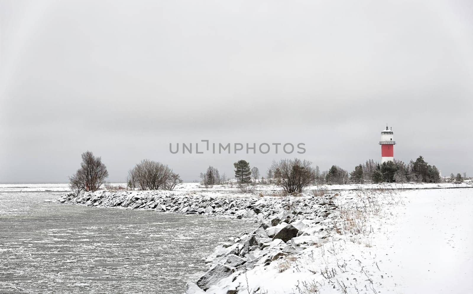 Light House with Icy Ocean and a cloudy sky.