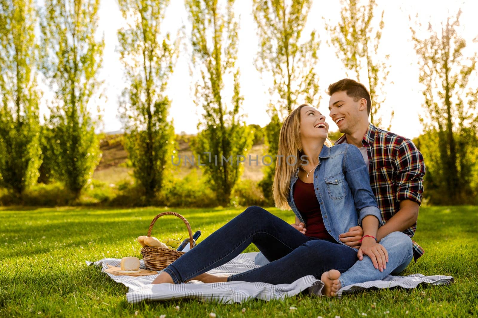 Shot of a beautiful couple on the park making a picnic and having fun