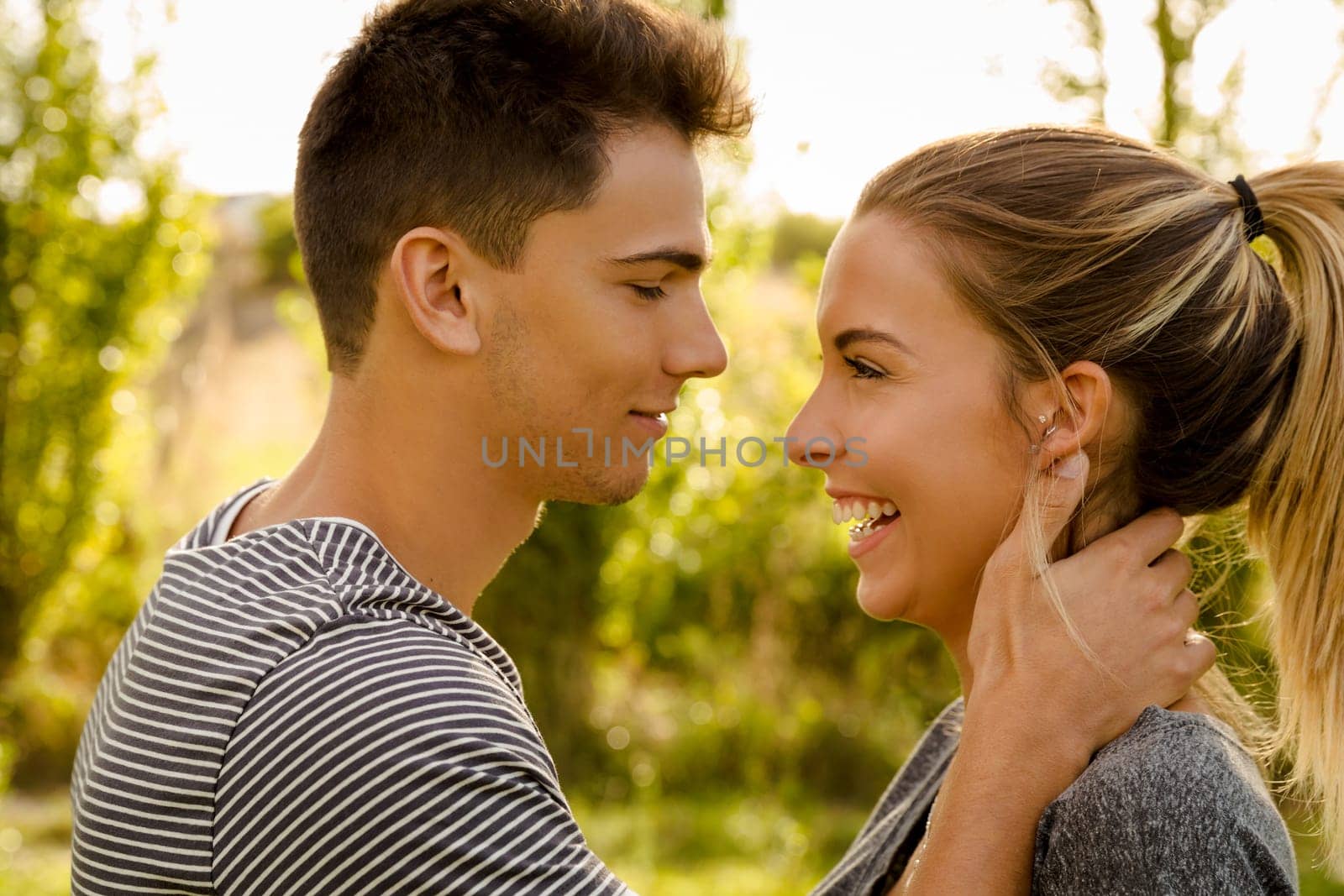 Portrait of a happy young couple in love and giving a kiss