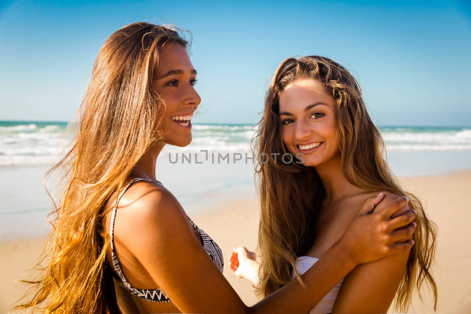 Beautiful girls in the beach giving her hands together