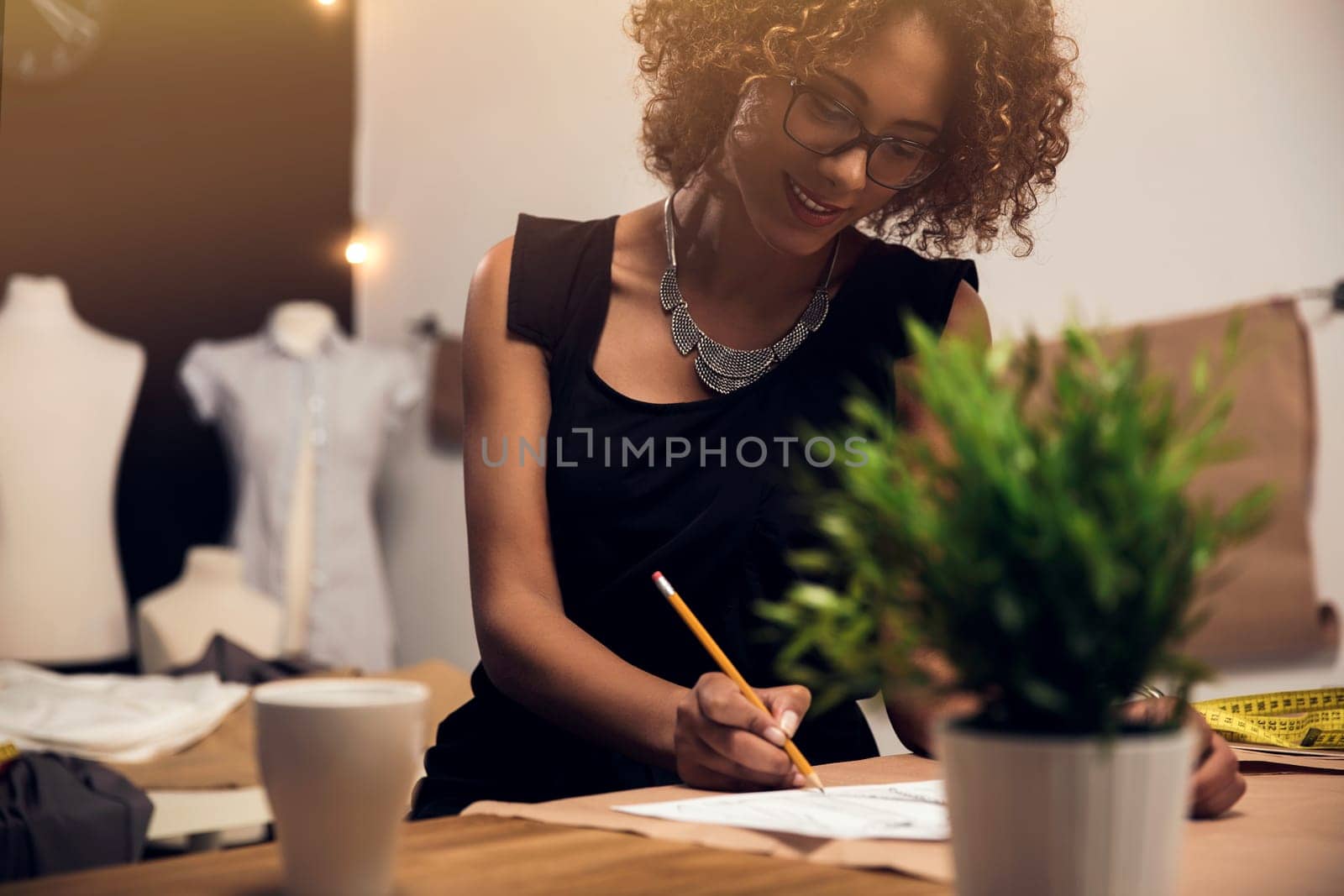 A young fashion designer working on her atelier