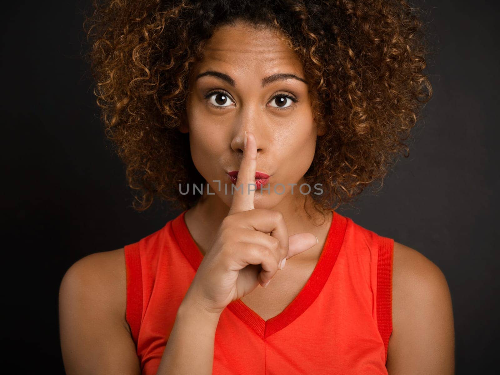 Portrait of a beautiful African American woman asking for silence