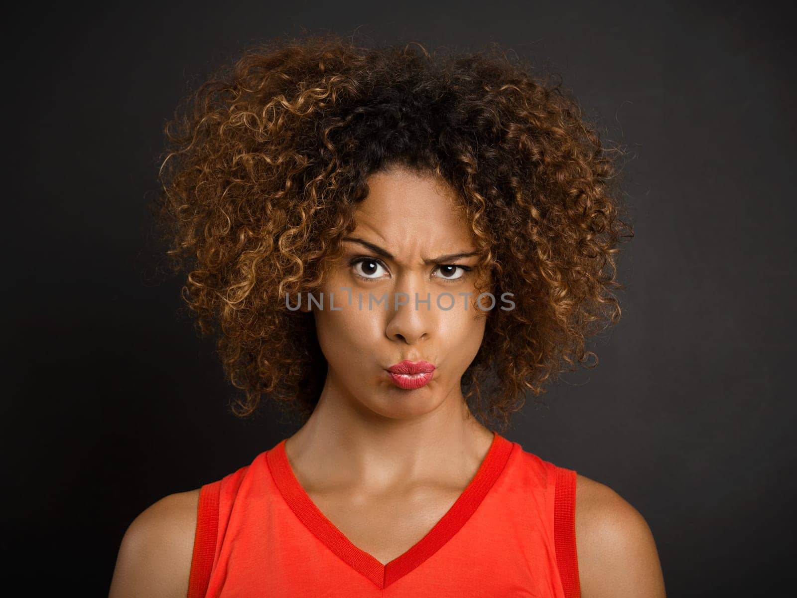 Portrait of a beautiful African American woman with a suspicious expression