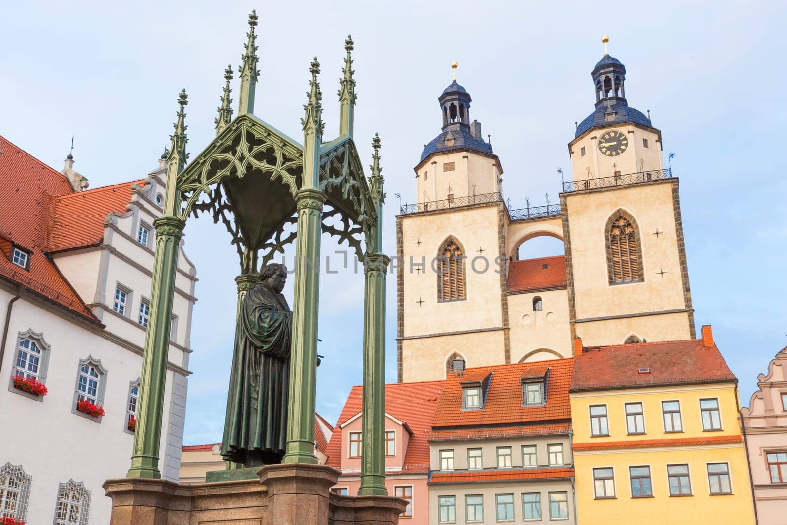 Luther monument on the Town Hall Square in Wittenberg with the City Church of St. Mary in the background