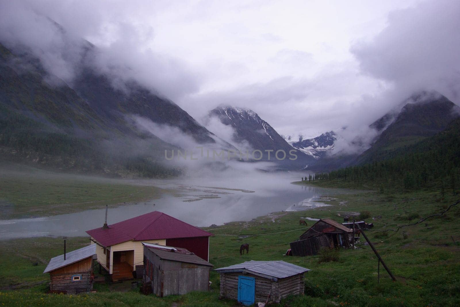 The mountain river in the mountains. Current through the gorge the river. Stones and rocky land near the river. Beautiful mountain landscape.