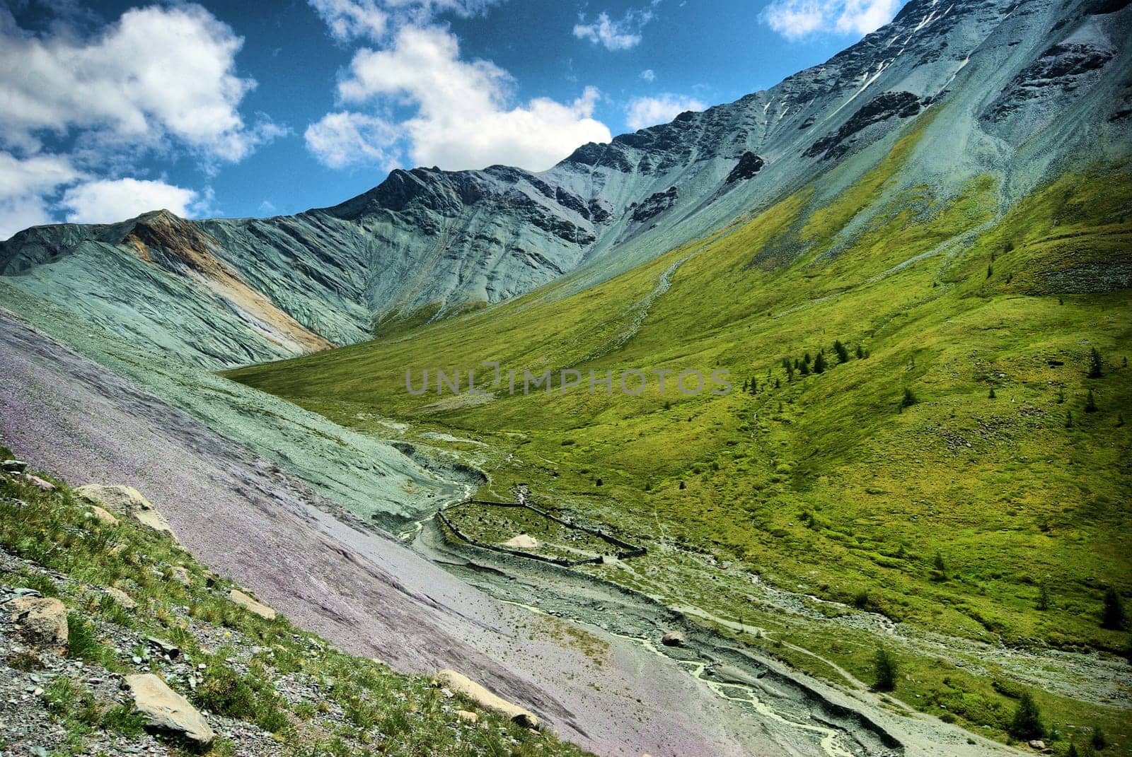 The mountain river in the mountains. Current through the gorge the river. Stones and rocky land near the river. Beautiful mountain landscape.