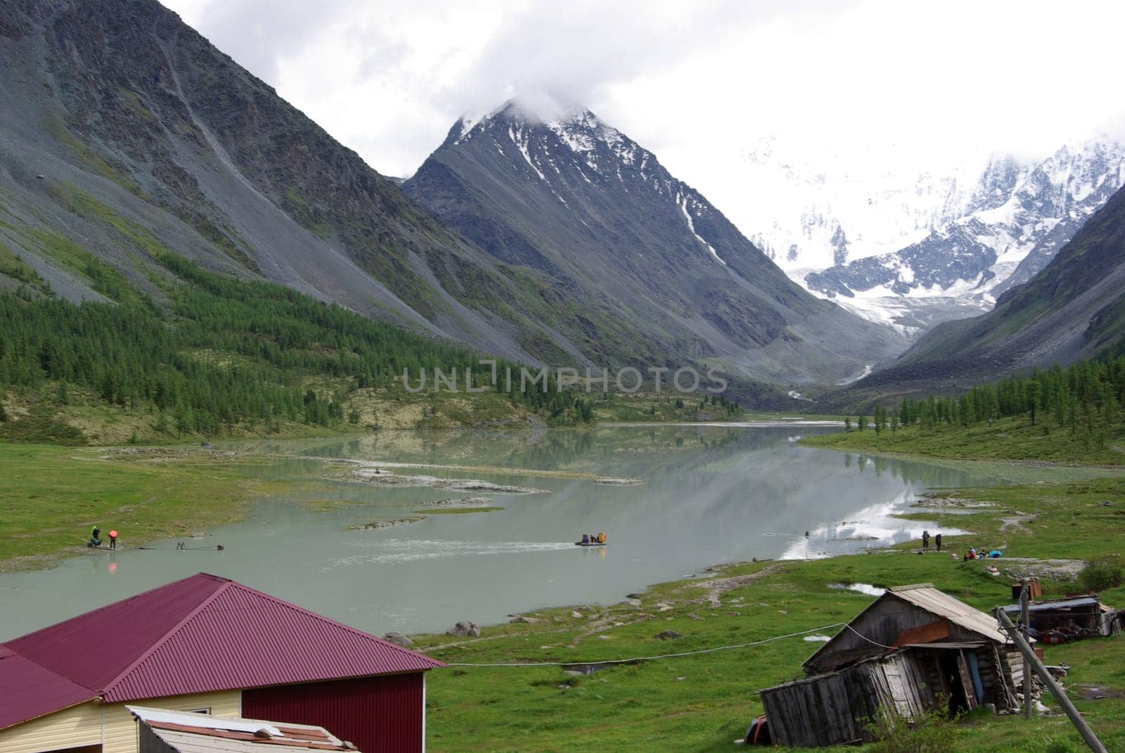The mountain river in the mountains. Current through the gorge the river. Stones and rocky land near the river. Beautiful mountain landscape.