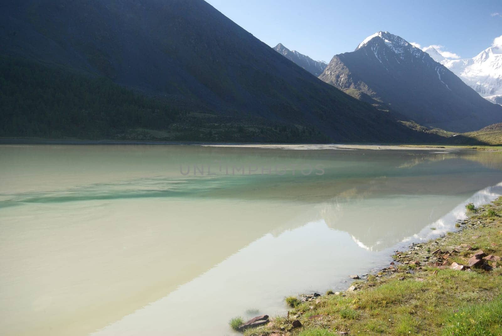 The mountain river in the mountains. Current through the gorge the river. Stones and rocky land near the river. Beautiful mountain landscape.