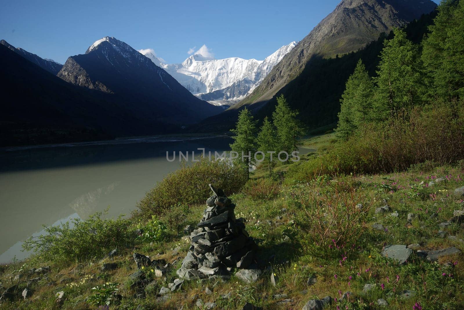 The mountain river in the mountains. Current through the gorge the river. Stones and rocky land near the river. Beautiful mountain landscape.