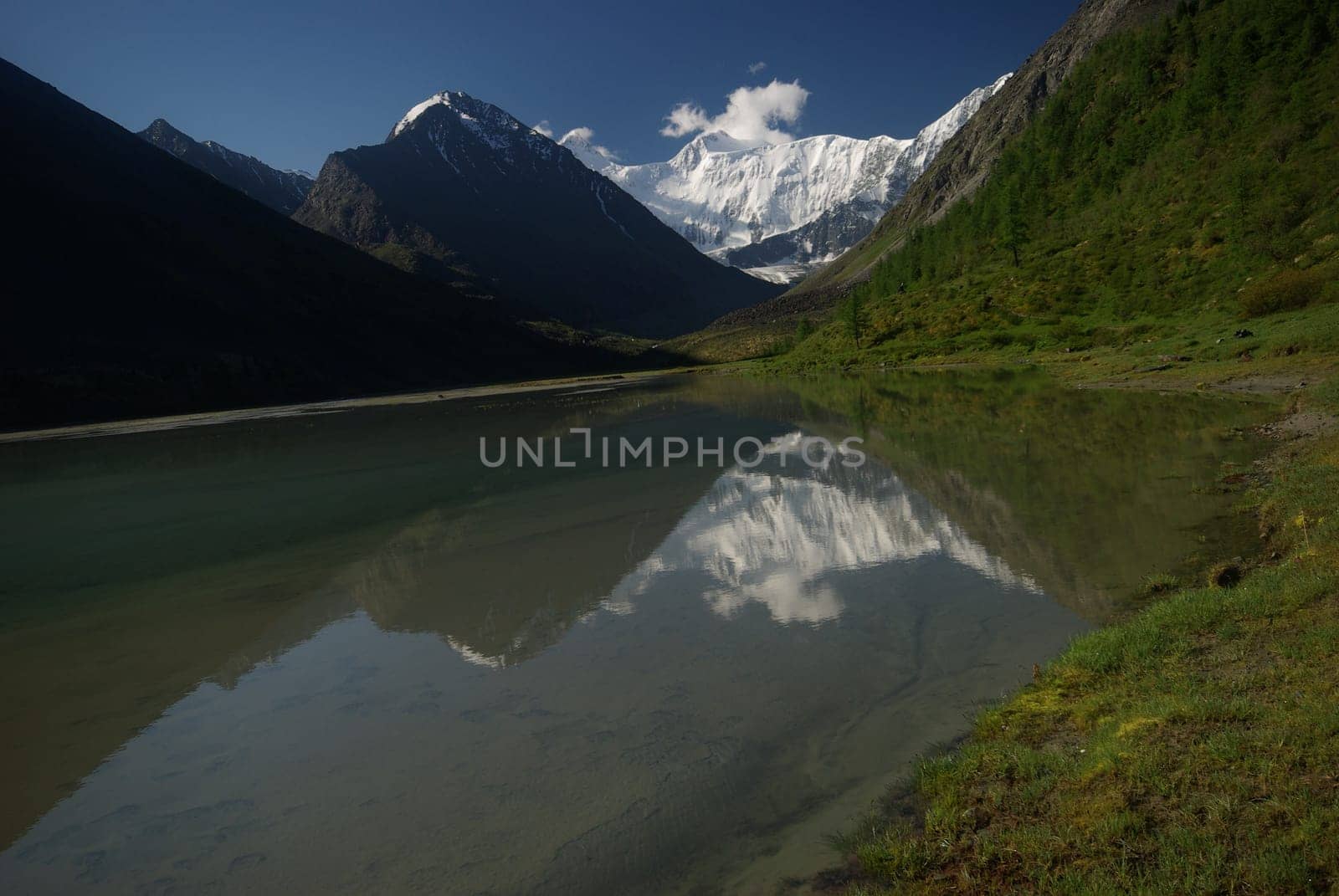 The mountain river in the mountains. Current through the gorge the river. Stones and rocky land near the river. Beautiful mountain landscape.
