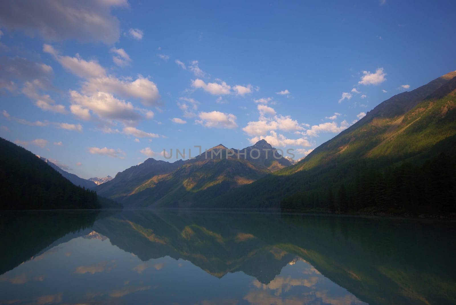 The mountain river in the mountains. Current through the gorge the river. Stones and rocky land near the river. Beautiful mountain landscape.