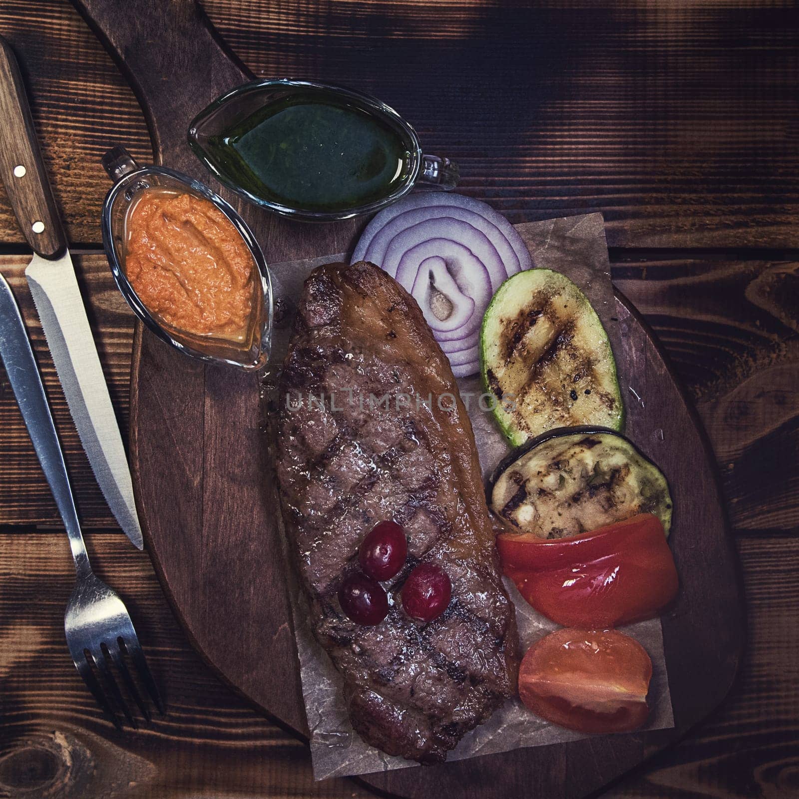 grilled beef steak with sauce and vegetables