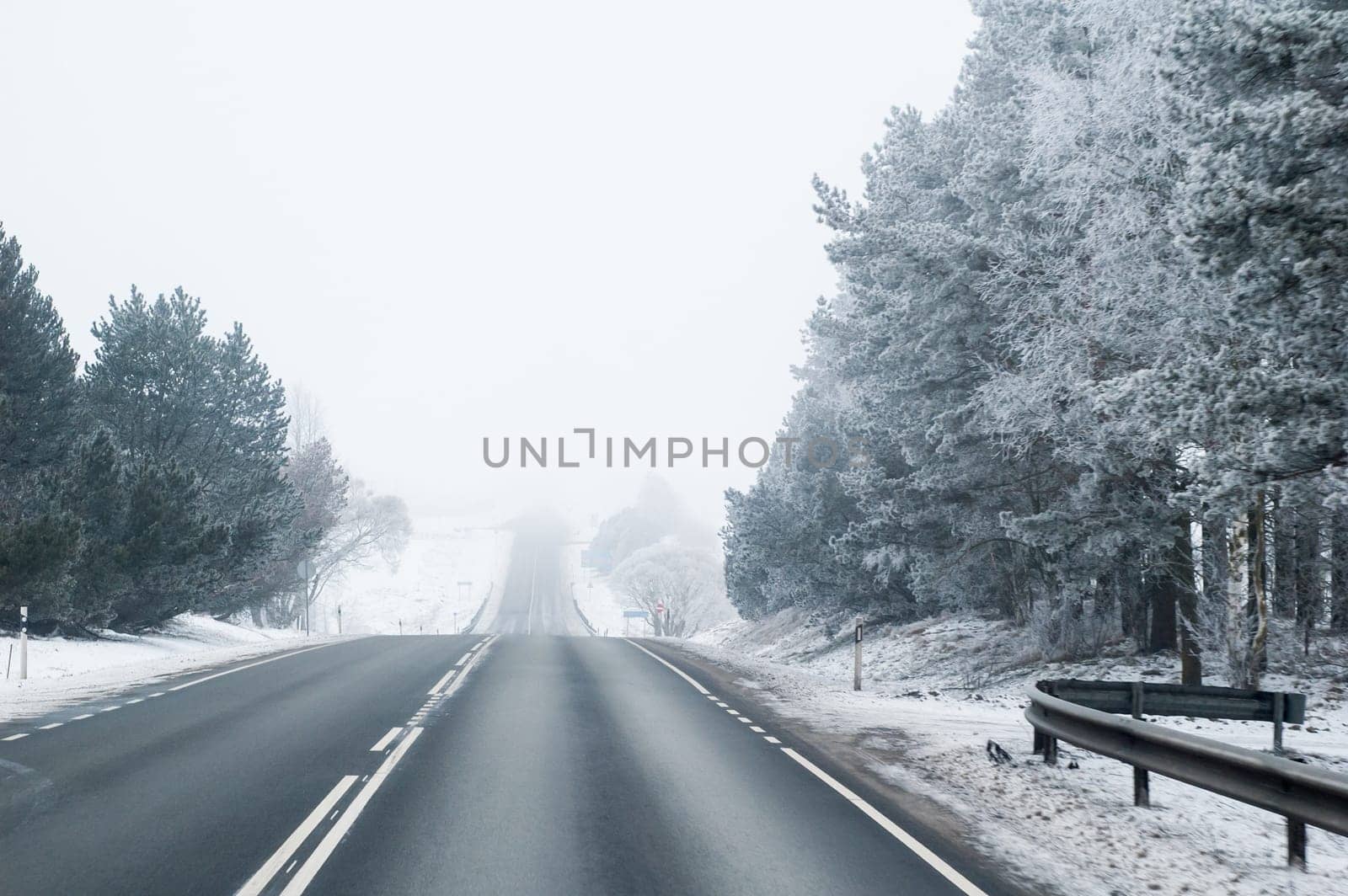 Highway in the winter, the trees covered with hoarfrost