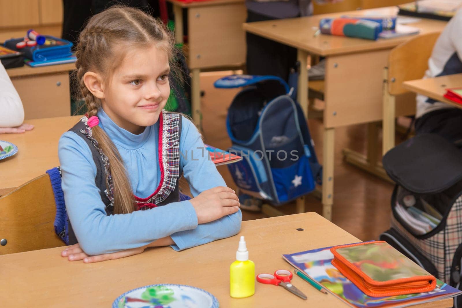 Happy first grader at a lesson in the school of technology