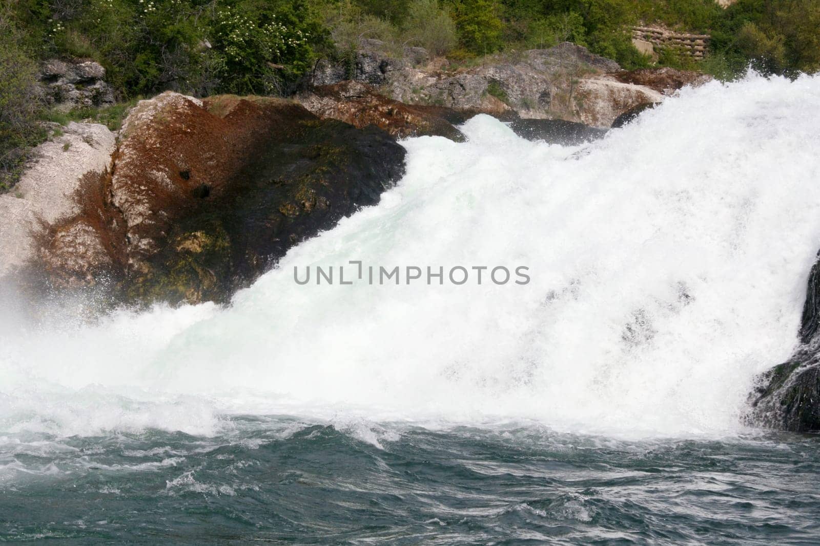 Waterfall with white,foaming spray