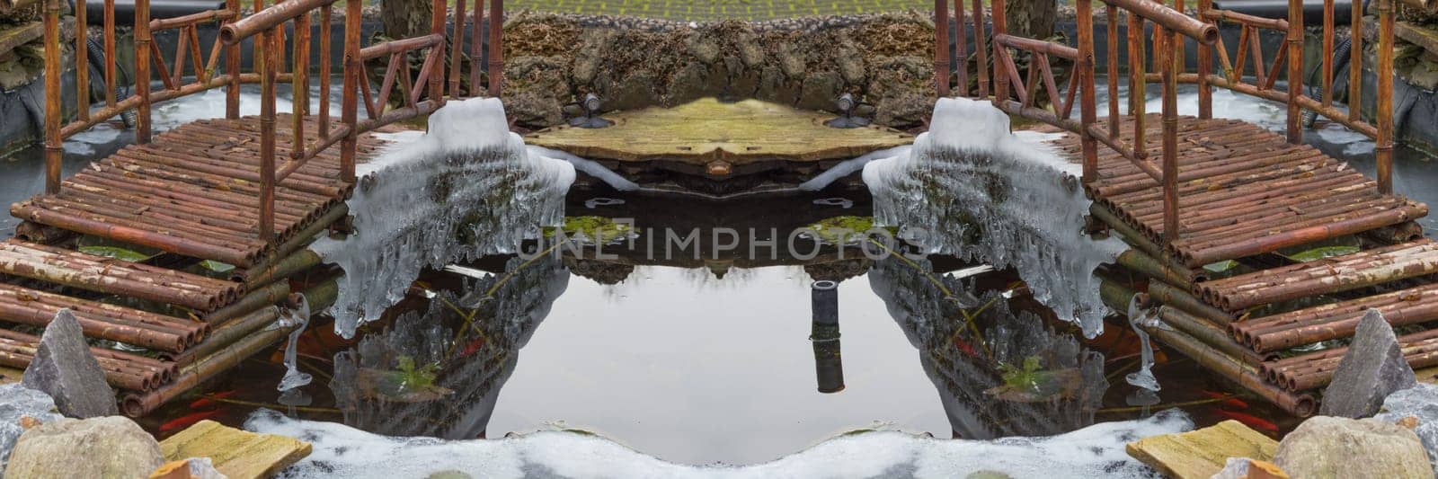 Icicles hang from a bridge over a frozen lake.