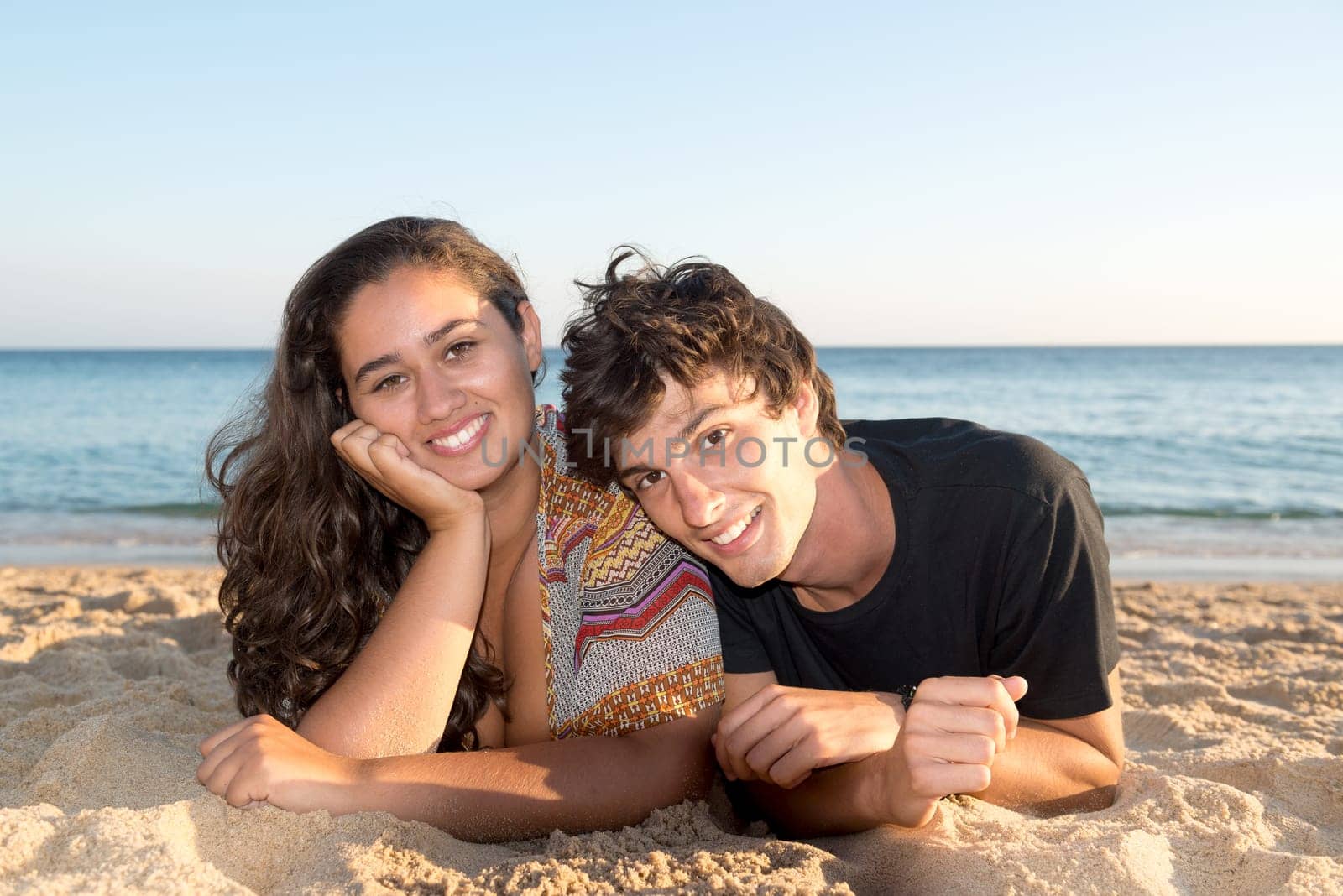Happy young couple posing in the beach