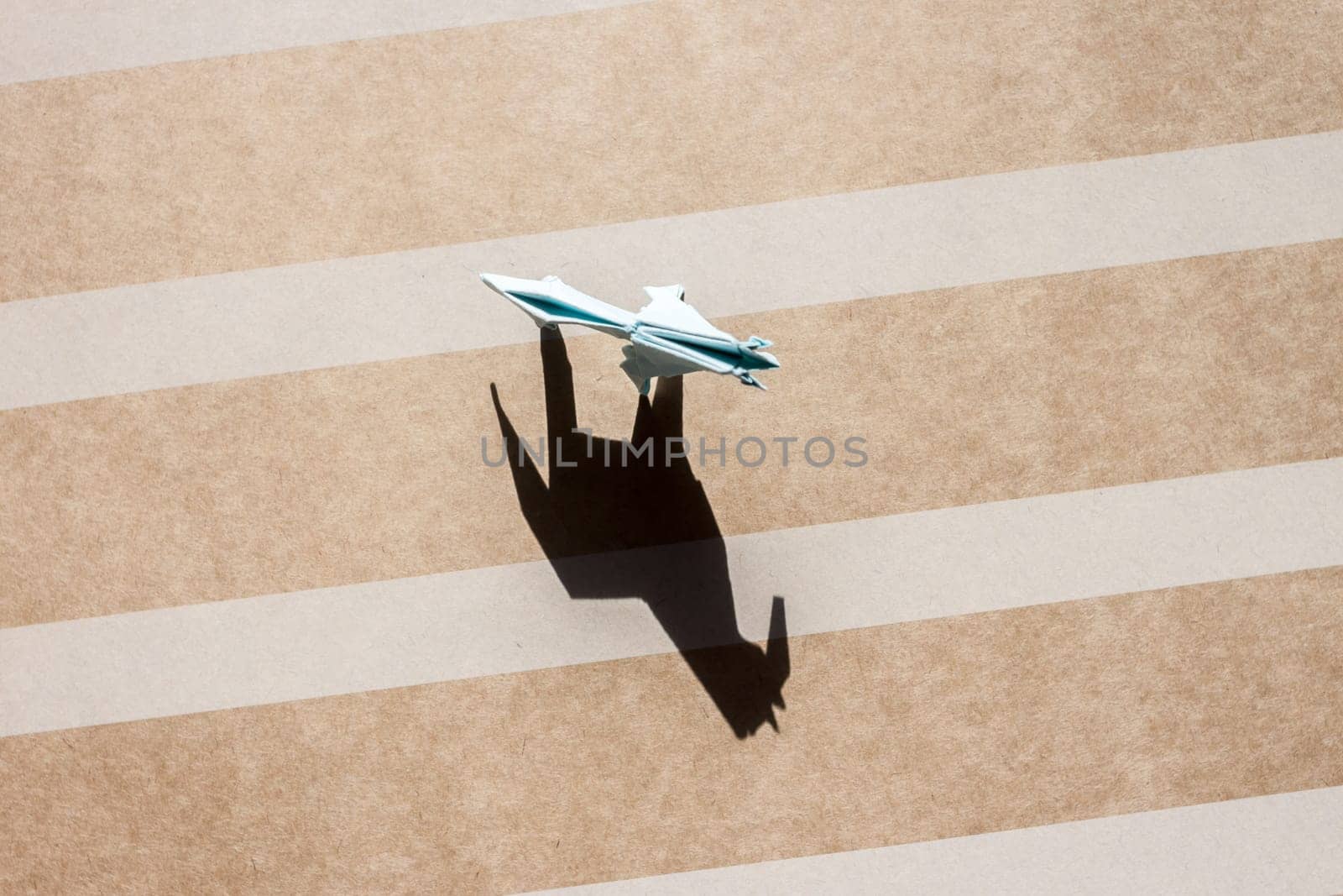 origami blue horse and shadow on paper field top view