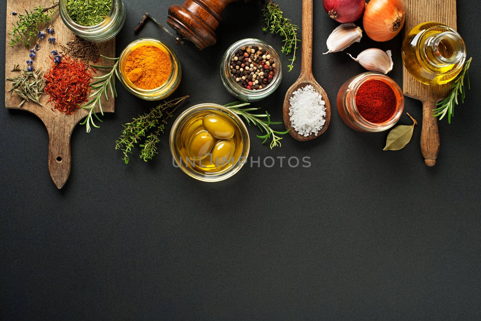 Fresh herbs and spices on a black background