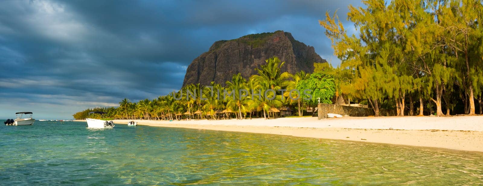 White sandy beach and Le Morne Brabant at sunset. Mauritius. Panorama