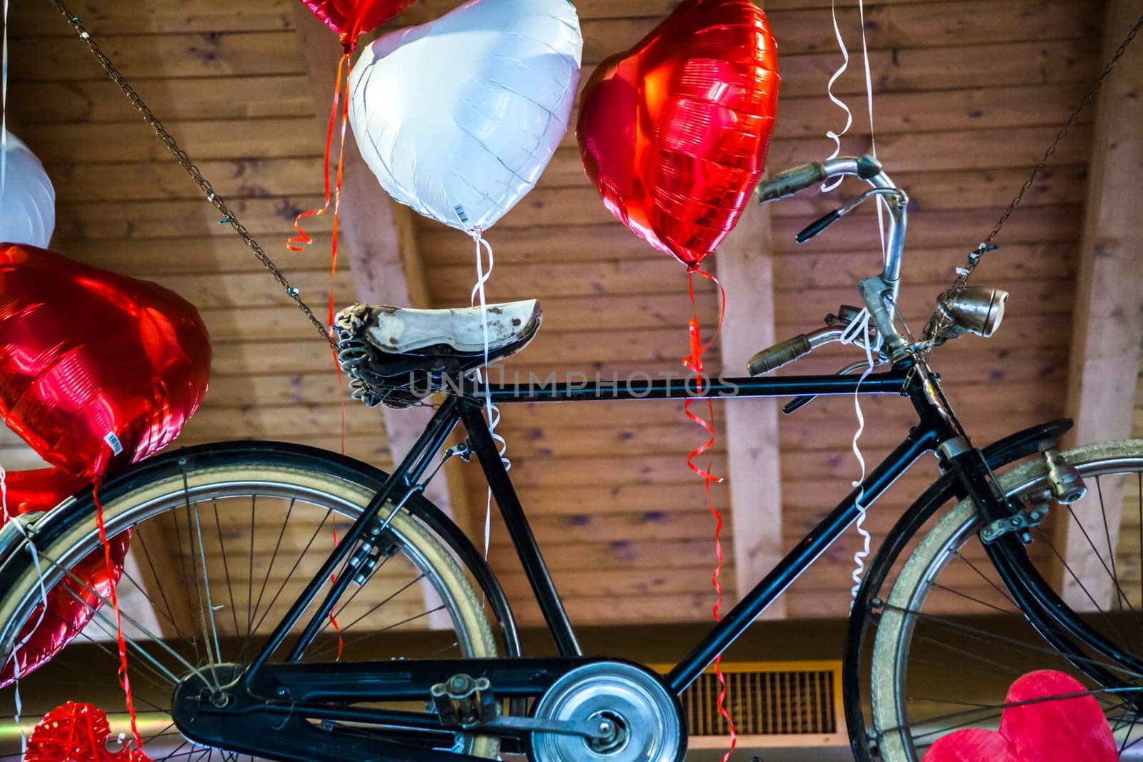 Flying bike bound to heart shaped balloons