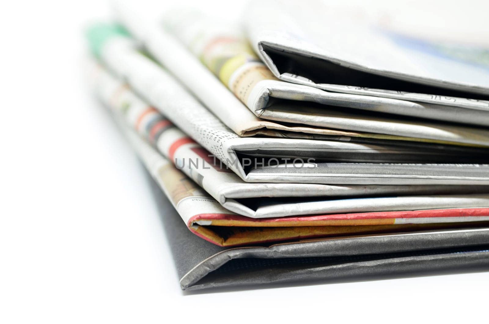 Newspapers folded and stacked isolated on white
