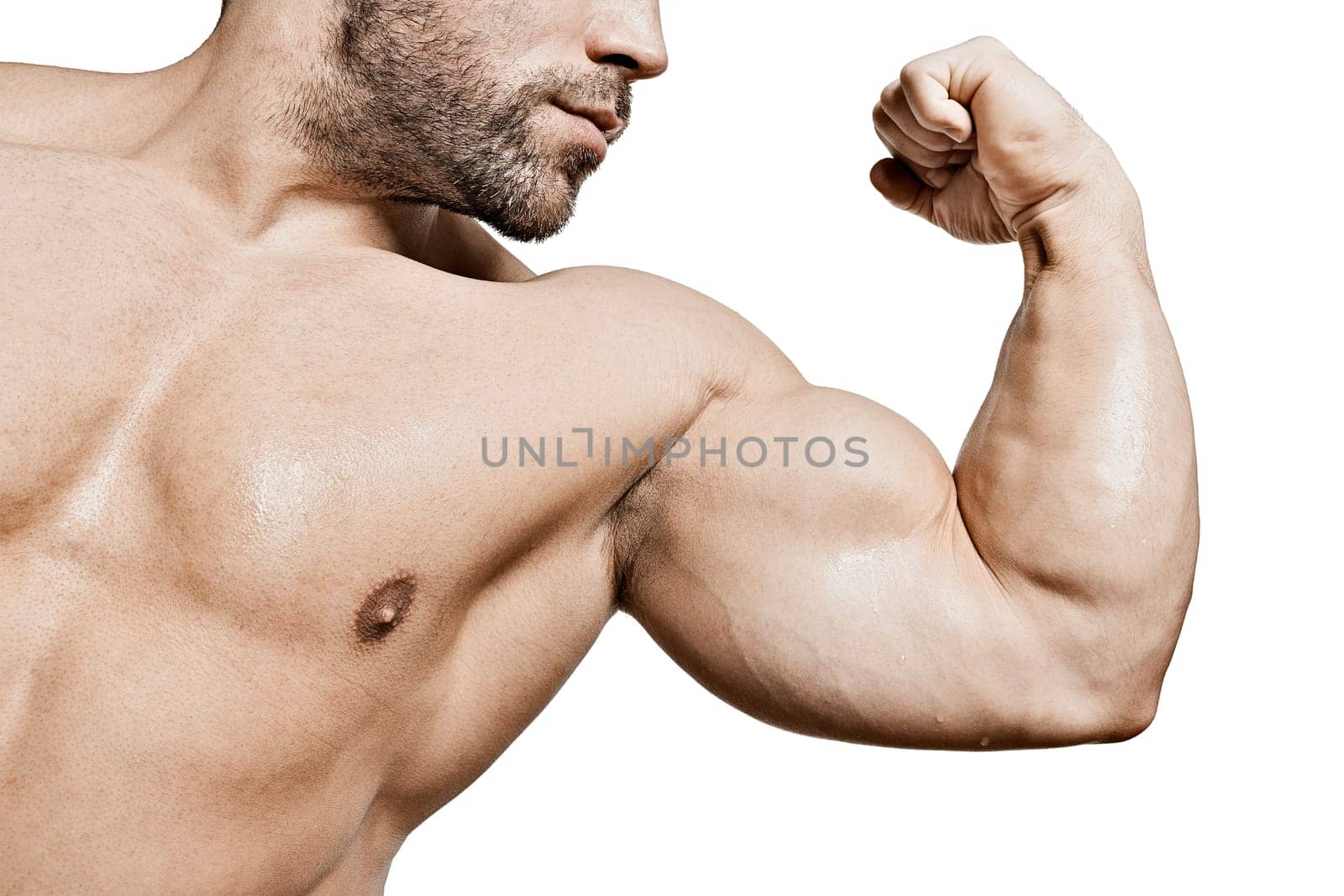 The biceps of a young,muscular man with a bare upper body