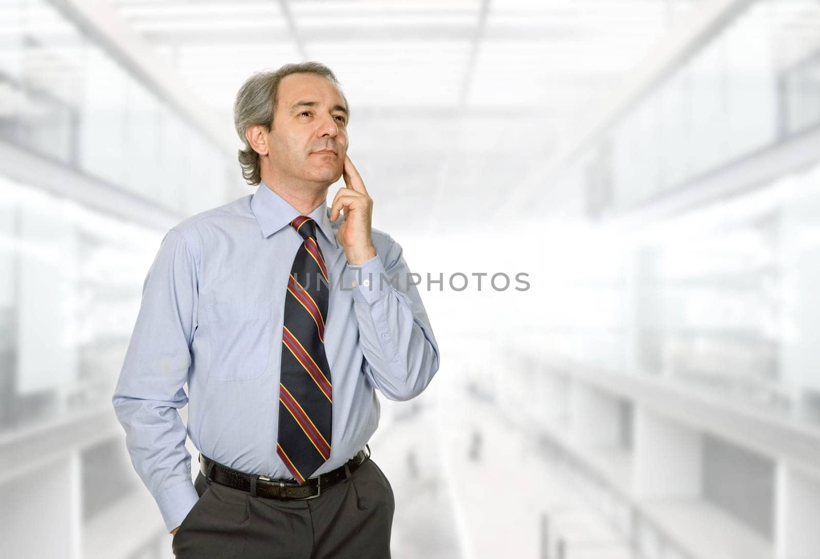 mature business man thinking, at the office
