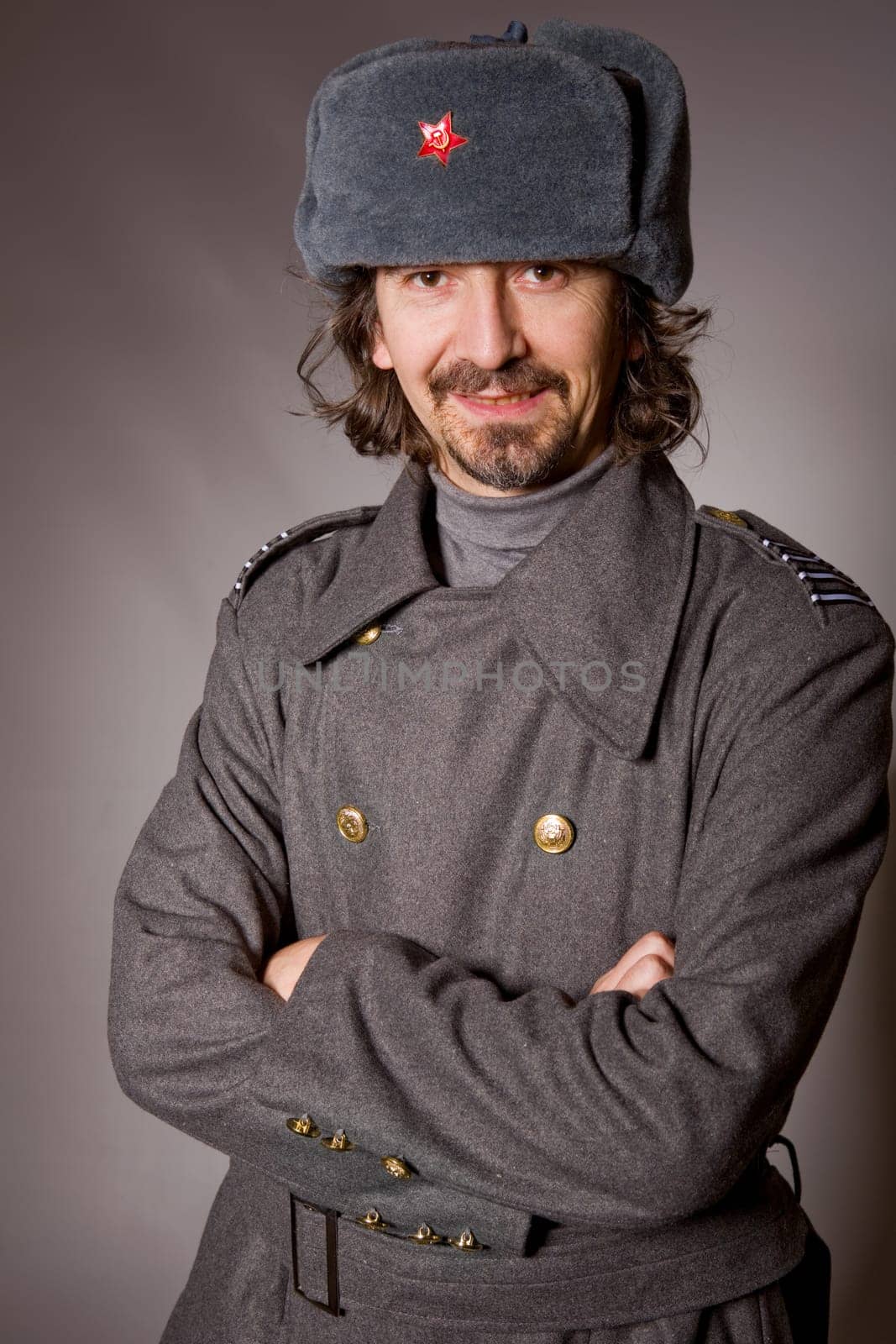 young man dressed as russian military, studio picture