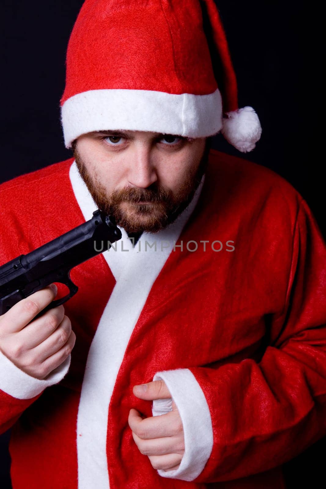 young man dressed as santa with a gun