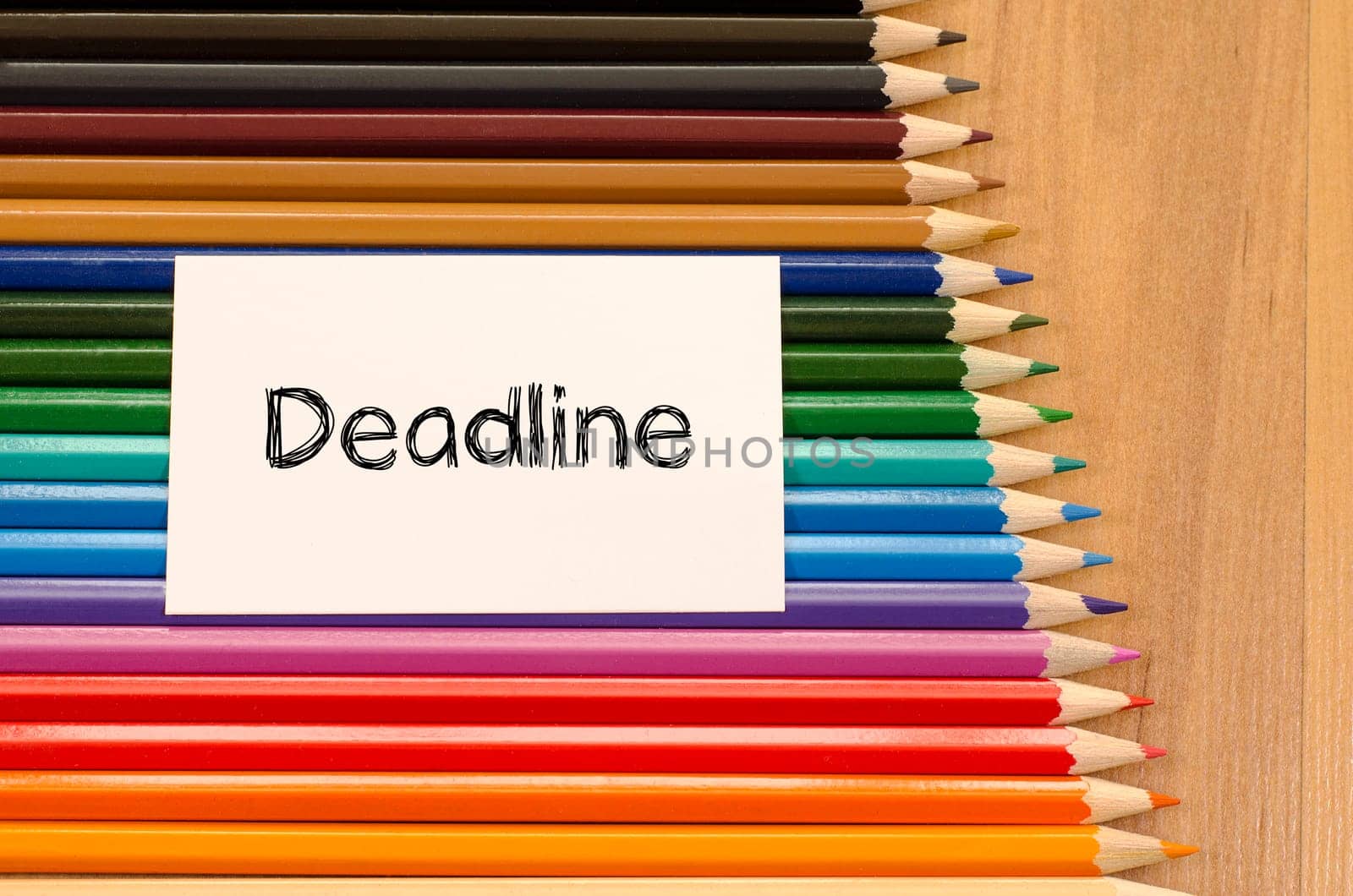 Blank white paper and colored pencil on wooden background