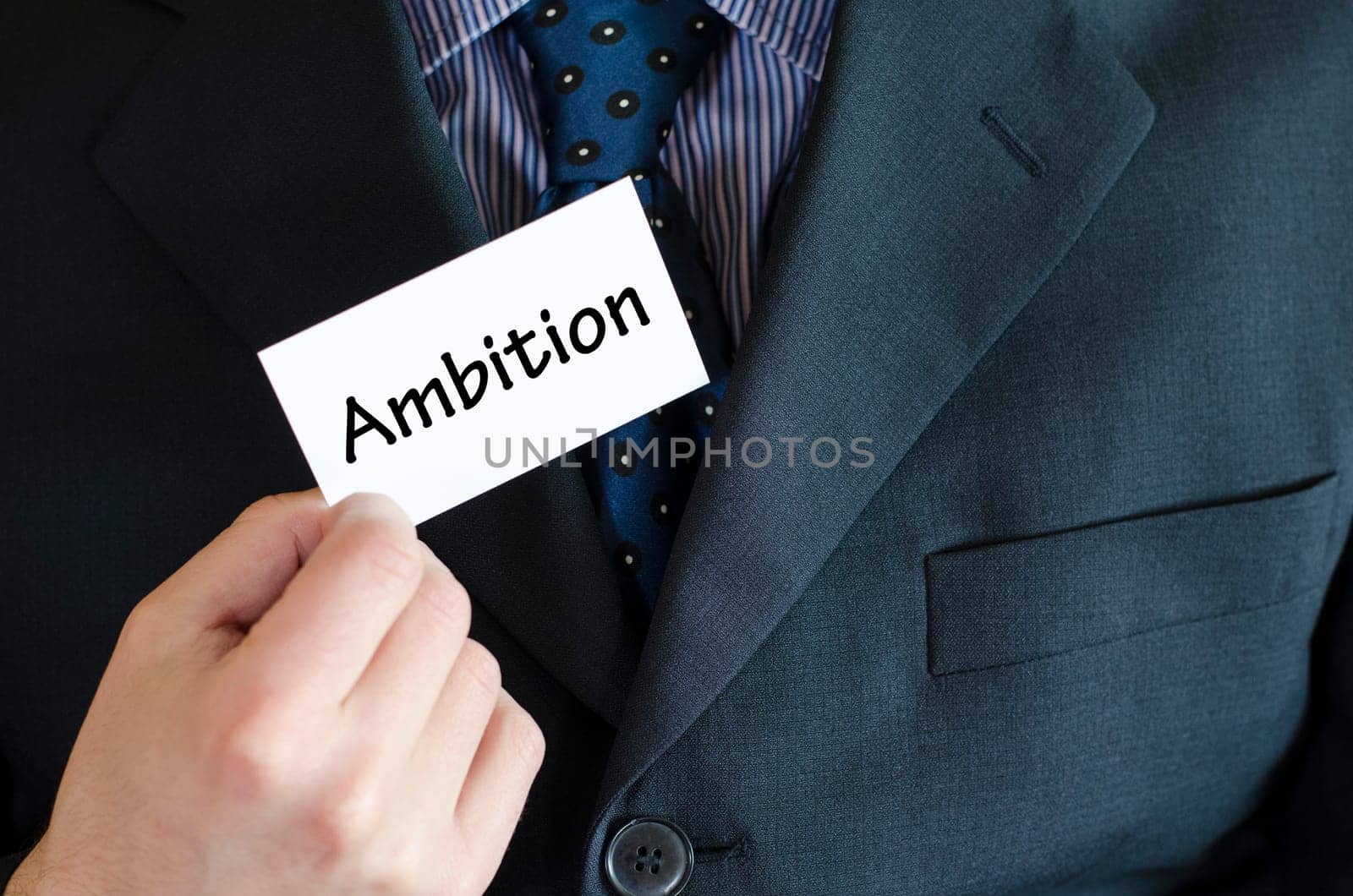 Ambition text note concept over business man background.