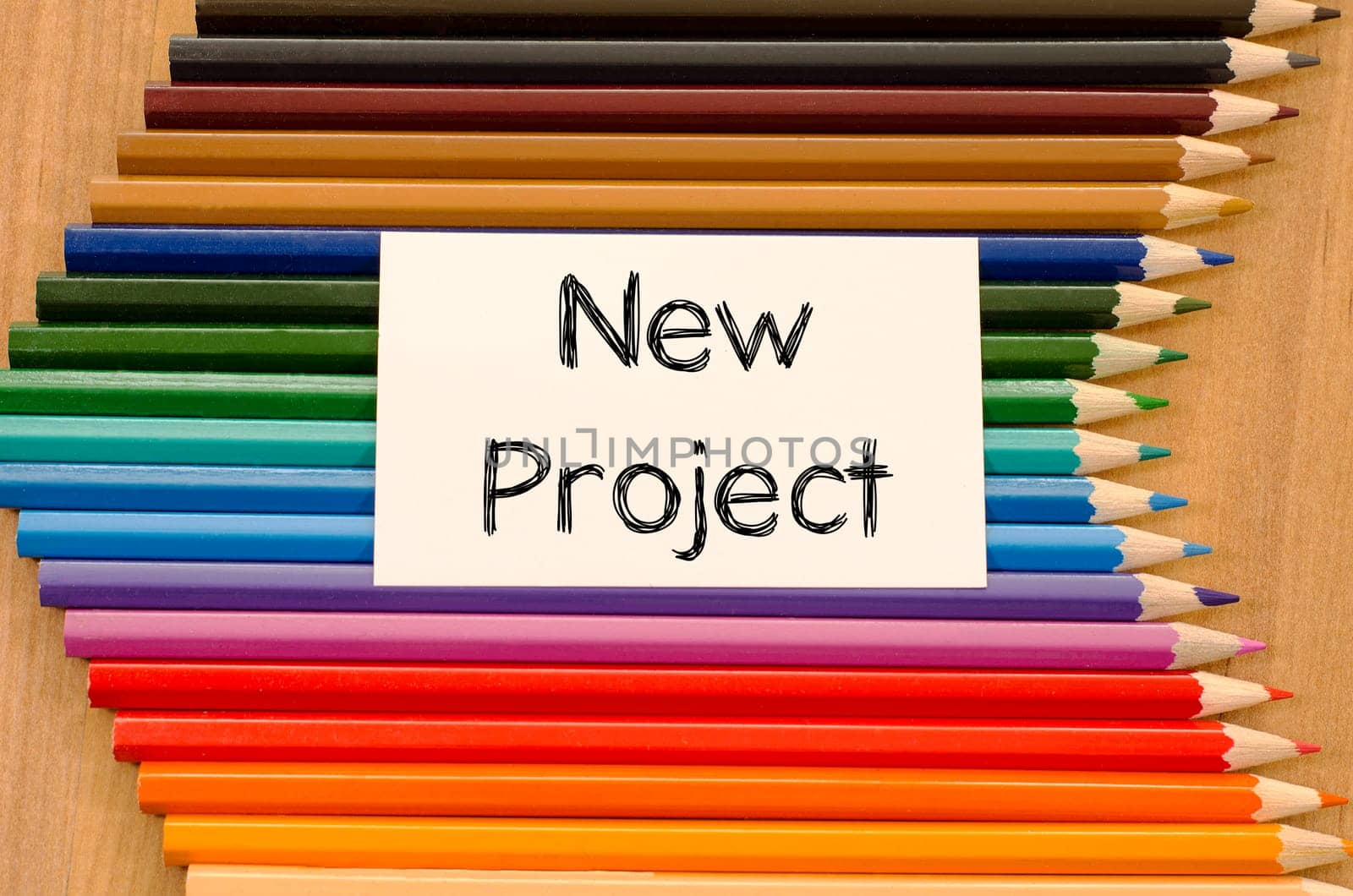 Blank white paper and colored pencil on wooden background