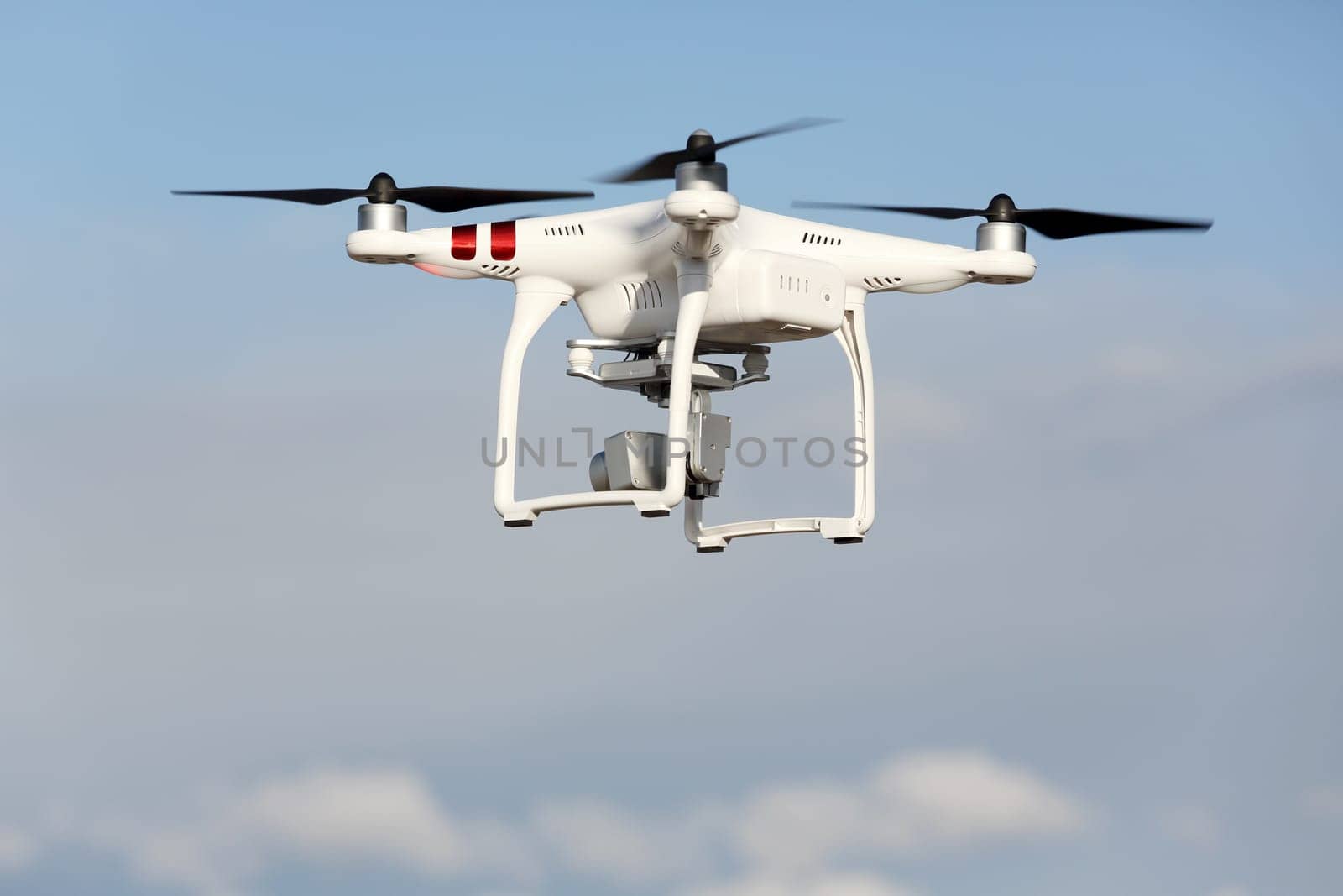 Drone quad copter with flying in the blue sky