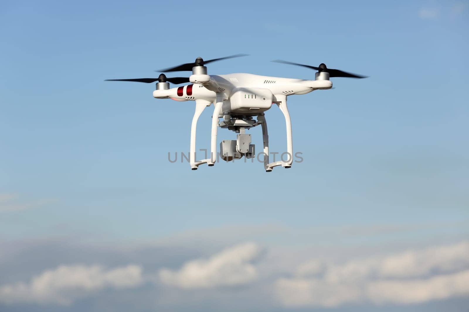 Drone quad copter with flying in the blue sky