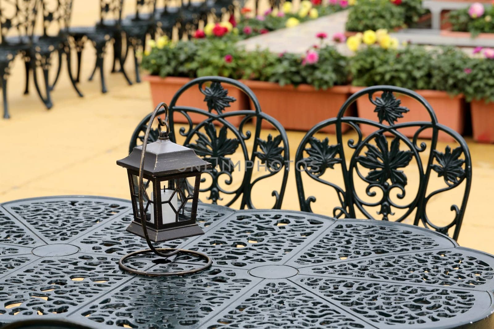 chairs and tables with old lantern, outdoor cafe