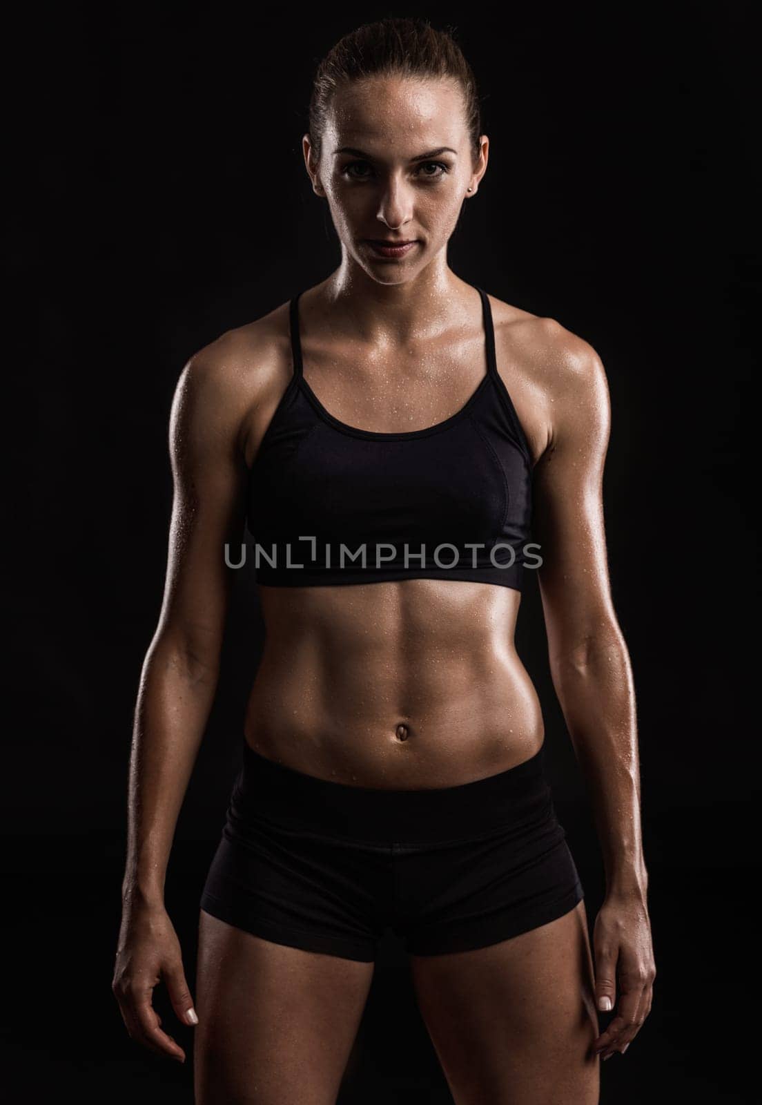 Studio portrait of a sporty young woman posing against a dark background