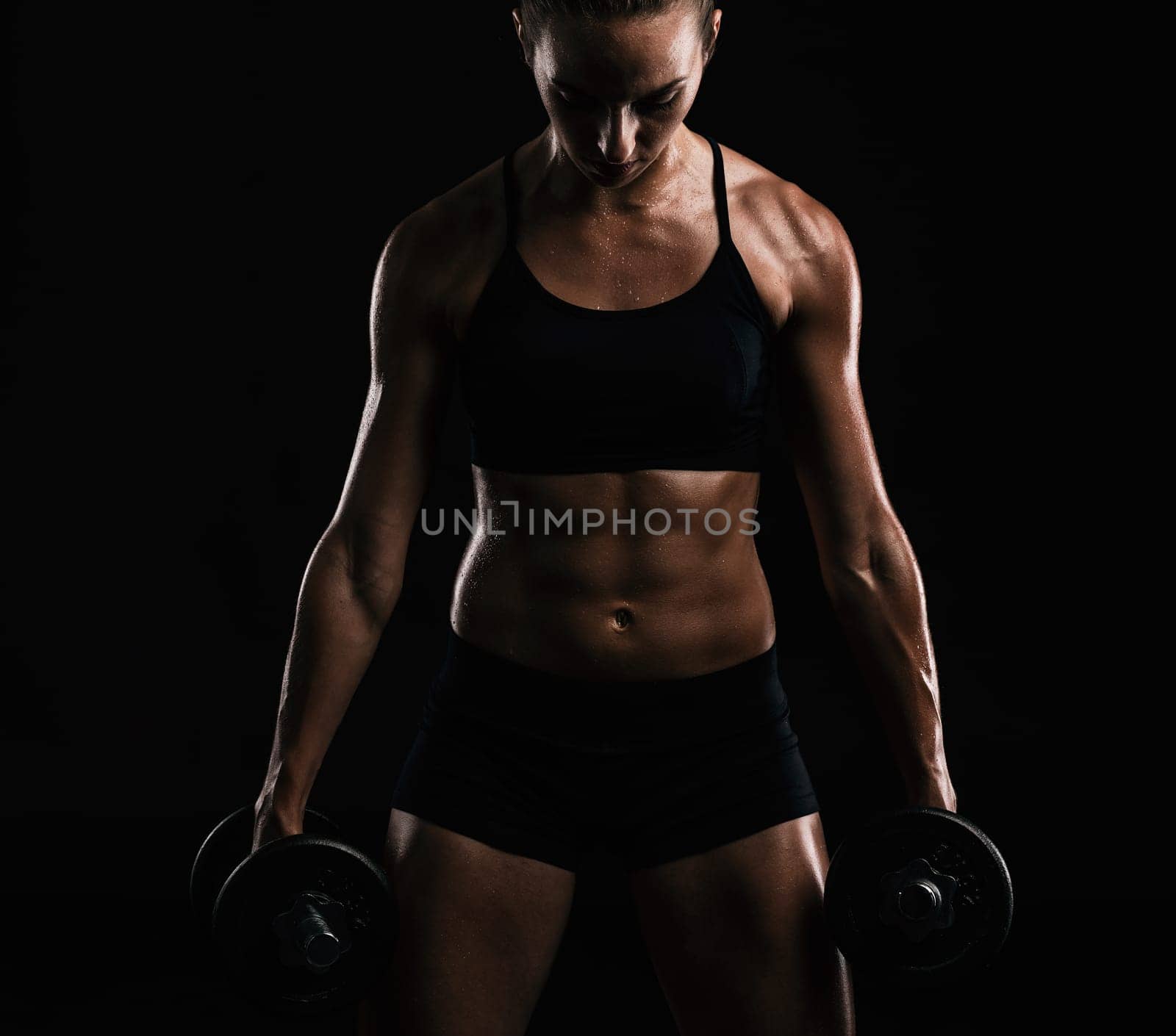 Studio portrait of a sporty young woman posing against a dark background