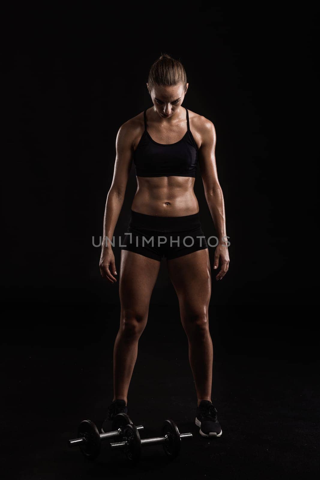Studio portrait of a sporty young woman posing against a dark background