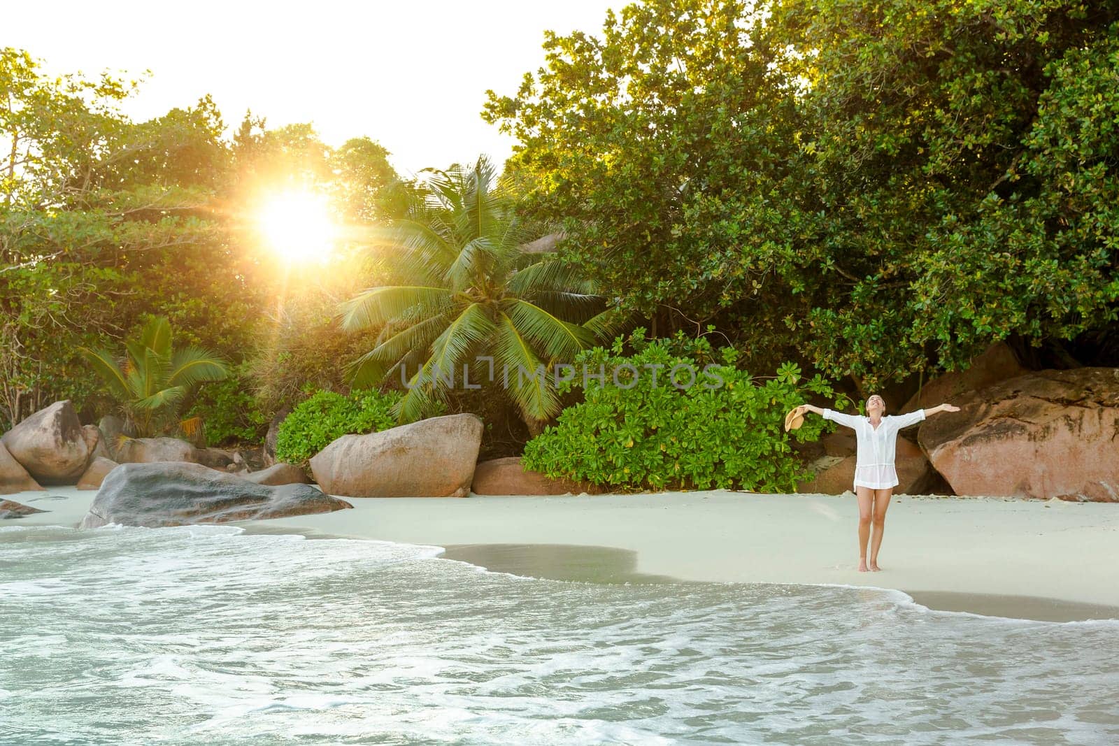 Beautiful woman enjoying the beautiful beachs of Praslin, Seychelles