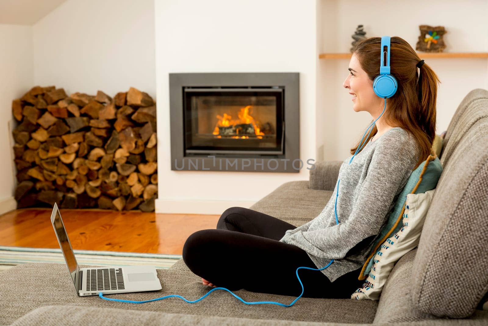 Beautiful woman at home and listen music
