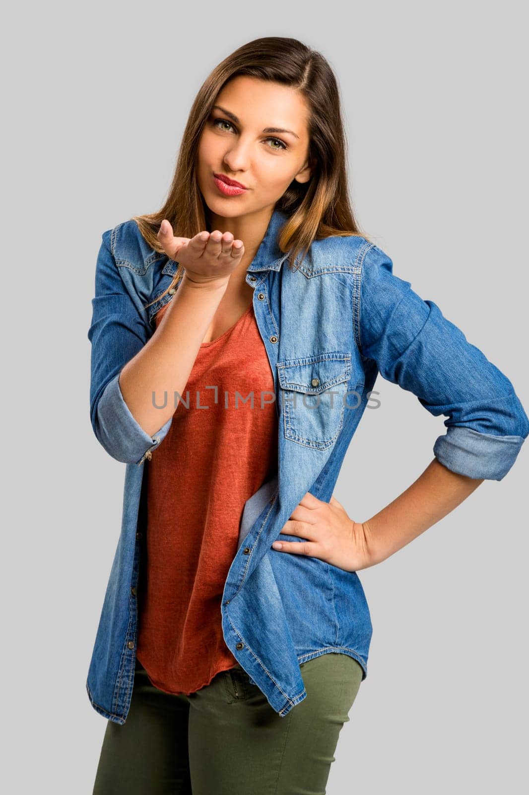 Beautiful and happy woman sending a kiss for you