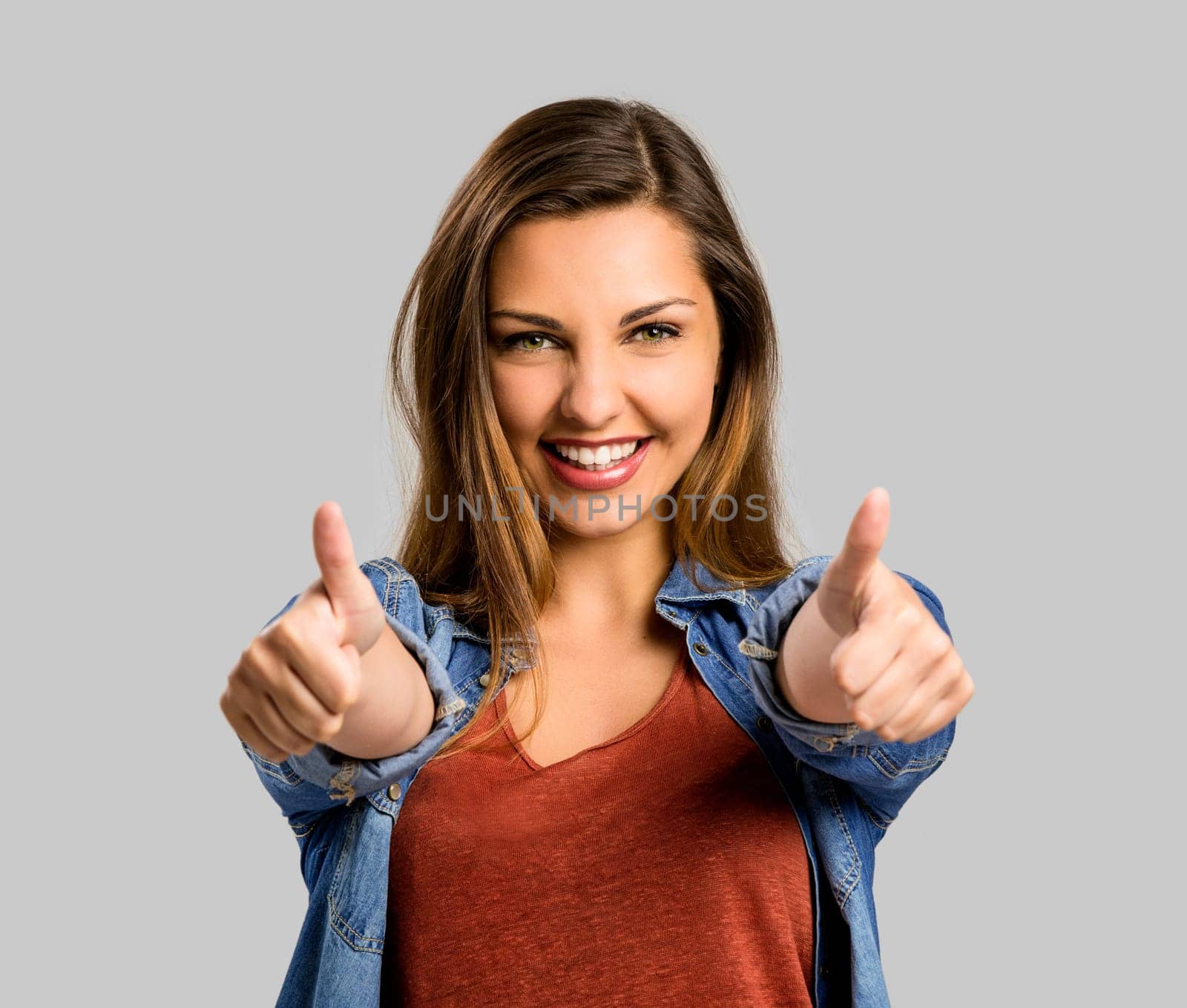 Beautiful and happy woman with thumbs up