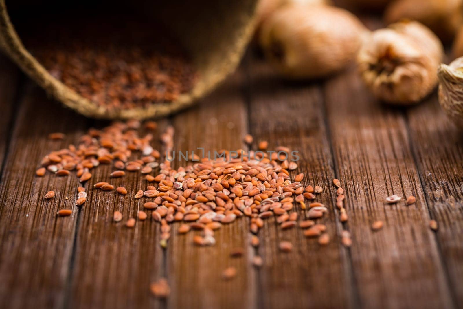 Seeds and onions on wooden table