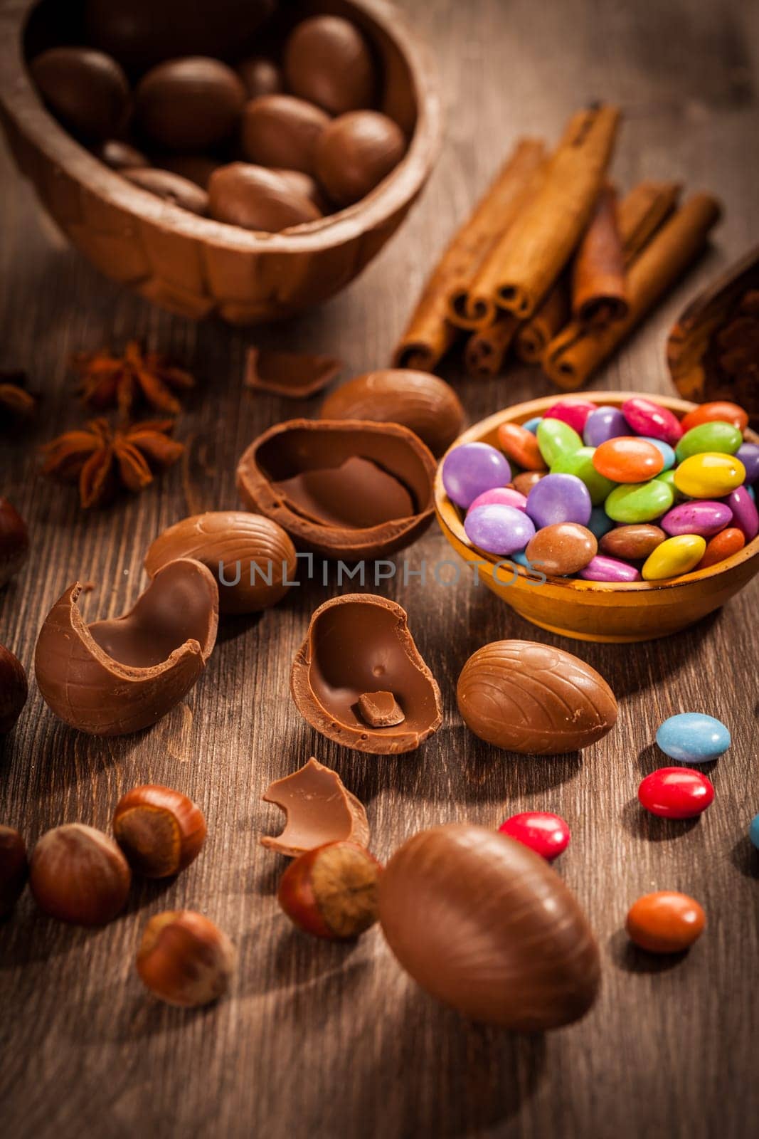 Assorted chocolate eggs for Easter on wooden background